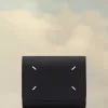 Cartera de cuatro puntadas Cartera de cuatro puntadas